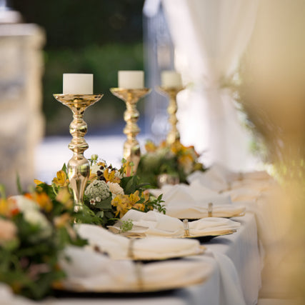 Wedding RentalsA close up of a wedding table with candle sticks, and plateware