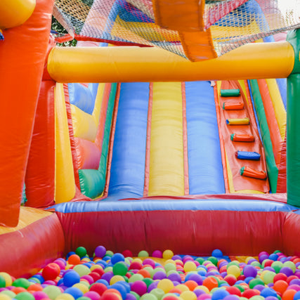 Party & Event RentalsAn inflatable slide with a ball pit at the bottom