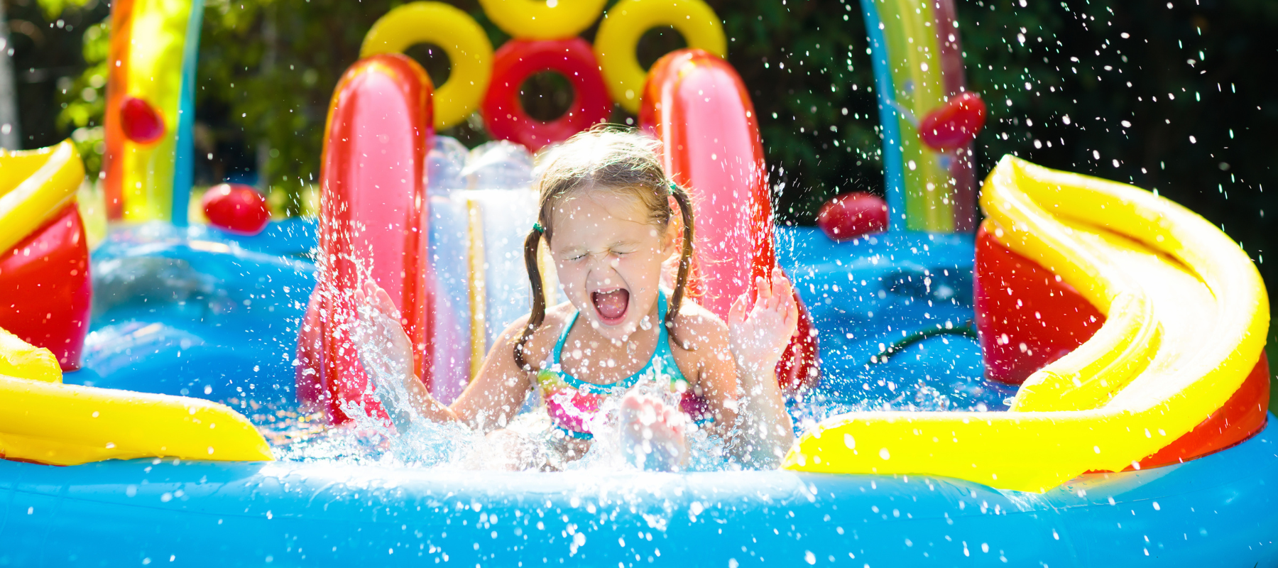 A girl sliding down an inflatable slip and slide